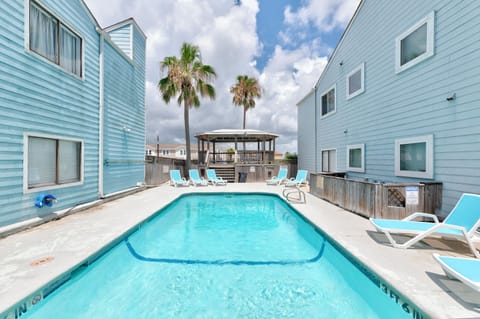 Enjoy a refreshing swim in the sparkling pool surrounded by lush greenery and cozy lounge chairs. Perfect for soaking up the sun or cooling off, this inviting area offers the ideal place to relax and recharge.