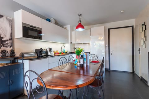Oudoor pool with a wooden deck, surrounded by Mediterranean greenery, perfect for relaxing under the blue  sky during holidays.