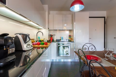 Elegant kitchen with modern appliances, tasteful decor, and artistic details creating a unique atmosphere.