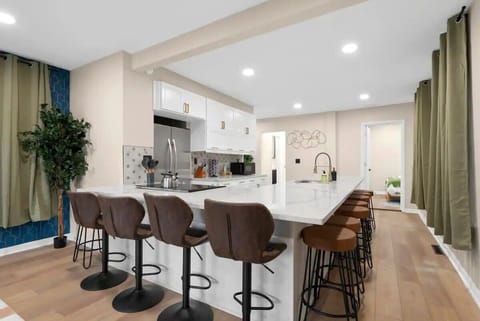 Fully stocked kitchen with Keurig, cookware, and stainless steel appliances