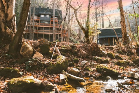 2 Cabins sit on 6 acres with tennis, pickleball and basketball basically on-site. Property hugs a creek throughout and is filled with a large lawn and 2 hot tubs!