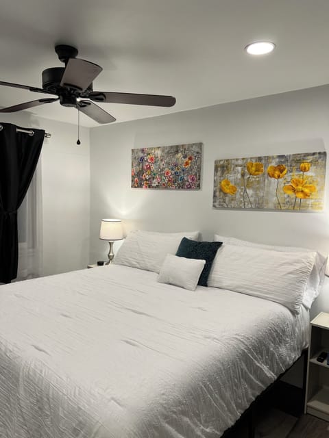 Upper bedroom w/king bed, 55” Fire TV, clothes storage w/luggage racks & hangers