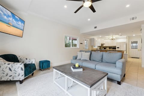 Bright and stylish living room with a large TV & comfy seating for unwinding.