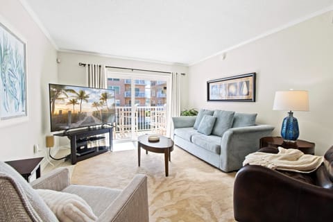 Bright & airy living room with sliding glass doors that lead to private balcony