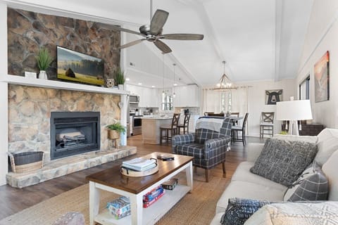 Open living space with comfortable seating, a fireplace and plenty of natural light.