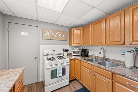 - Fully equipped kitchen with gas stove and appliances - Ample counter space for preparing home cooked meals - Relax sign and warm design create a cozy cooking space