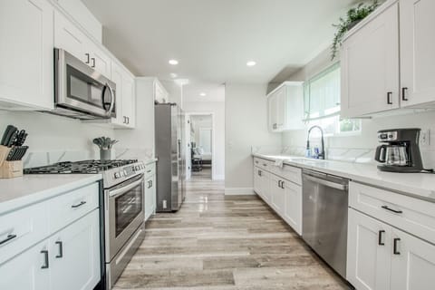 Modern kitchen with stainless steel appliances and sleek countertops.