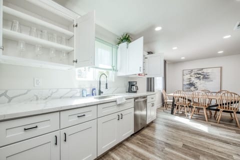 Modern kitchen with sleek counters and a cozy dining area.