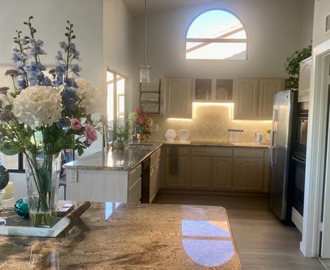 Kitchen with Induction cooktop, microwave, air fryer, oven, drawers.