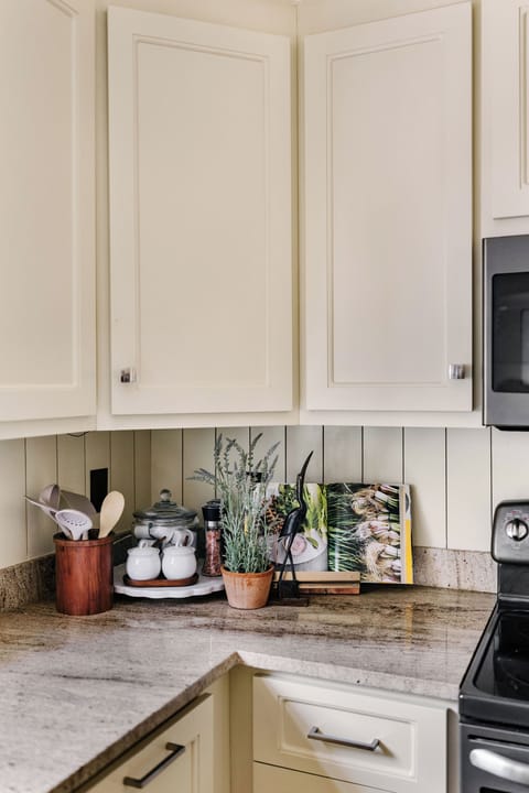 Fully stocked kitchen with essentials for cooking including Keurig coffee maker.