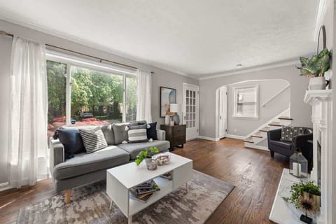 Relaxation central! Sink into this cozy couch in a charming living room with warm hardwood floors. Perfect spot for unwinding after a long day. ️