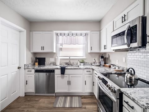 Step into this dreamy kitchen where the white cabinets shine as bright as your culinary creations! 🍽️ #KitchenGoals
