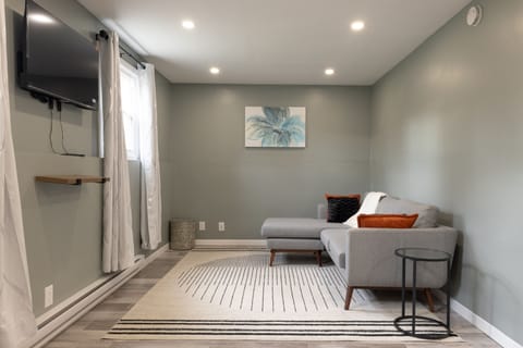 Spacious Living room with couch and Smart TV.