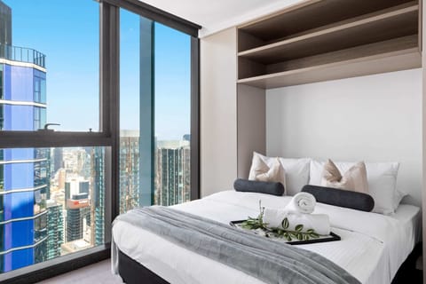 The master bedroom with a queen sized bed & plush pillows.