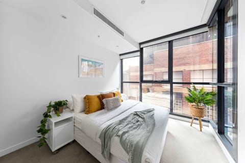 The master bedroom with a queen sized bed & plush pillows.
