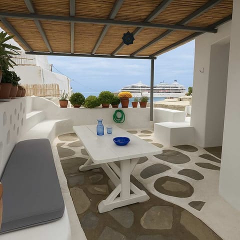 Shaded outdoor seating with sea view – ideal for relaxing moments


