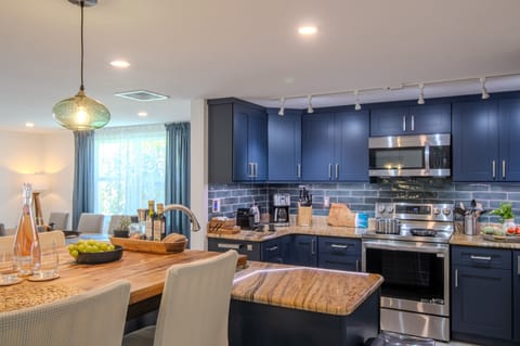 The breakfast table is conveniently located next to the kitchen