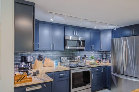 Fully equipped kitchen with French door refrigerator, range and dishwasher