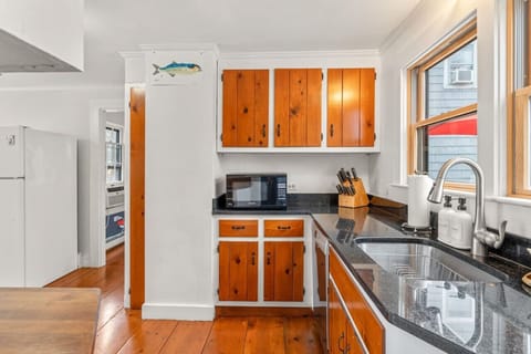 Fully-stocked kitchen with all the appliances & utensils you might need to cook at home.