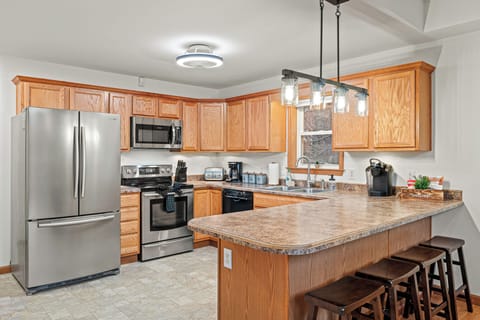 This kitchen combines modern stainless steel appliances with the timeless beauty of wood cabinets.
