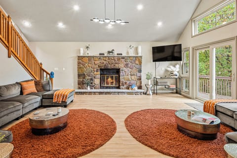The living area features a cozy fireplace with direct access to the deck.