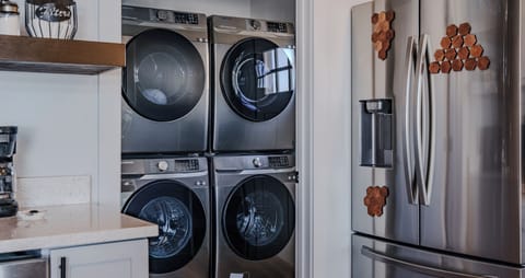 Two washers and driers in the mudroom