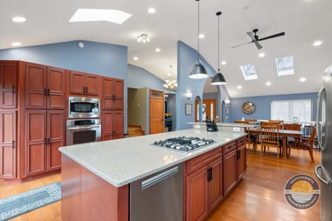 This fully equipped kitchen features a large island, modern appliances, and plenty of counter space for preparing meals, snacks, and shared moments.