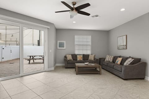 Modern living room with comfortable seating and access to a private patio.
