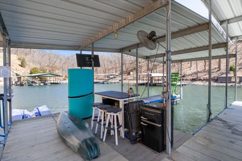 Relax on the lakefront dock equipped with seating, a kayak, and convenient amenities for your outdoor enjoyment.