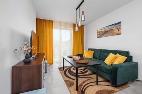 Living room with a comfortable sofa and TV. 