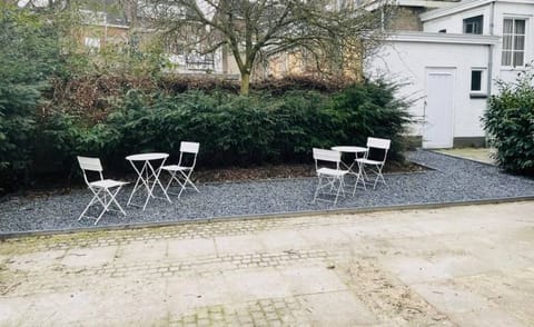 Outdoor seating area with charming chairs, perfect for enjoying the fresh air and relaxing in a peaceful garden setting.