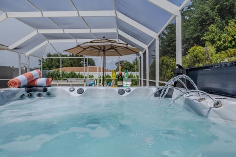 Spa Oasis - - Relaxing hot tub in a screened-in area, perfect for unwinding in comfort and privacy
- Surrounded by beautiful greenery and plenty of seating for a tranquil retreat
- Ideal for relaxing after a swim or enjoying peaceful evenings under the stars