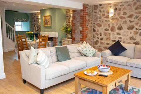 Large sofa and coffee table with dining area behind