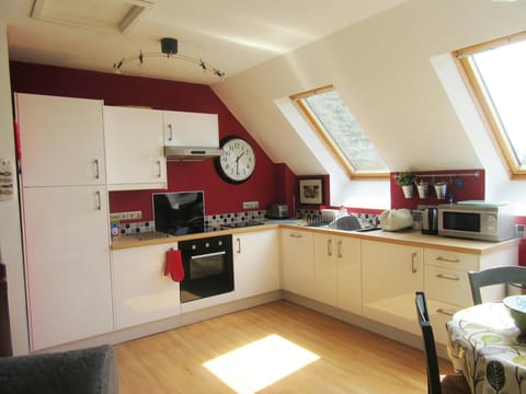 Kitchen with oven and hob, microwave, toaster and kettle