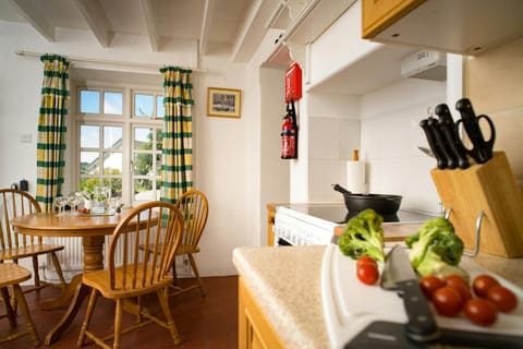 Table and chairs next to window in the kitchen at Garden Cottage