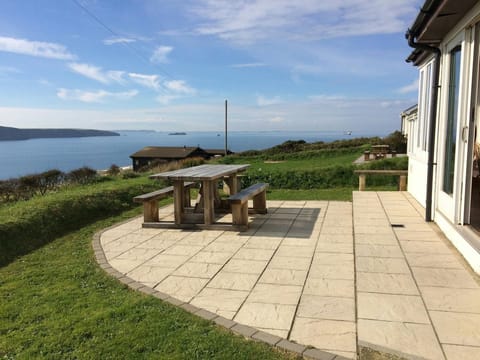 Patio with seating and stunning views across St Brides Bay