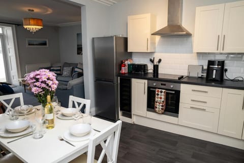 Dining table and chairs. Open plan leading into the sitting room
