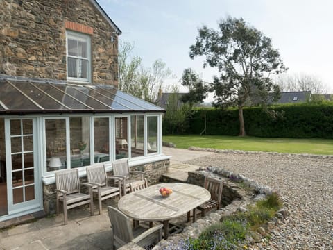Patio area with outdoor table and chairs looking towards the garden