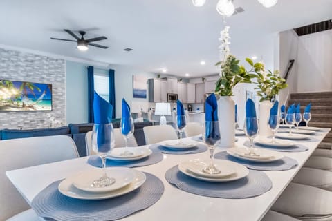 Elegant dining area with stylish table setting, modern decor, and open layout
