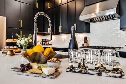 Indulge in culinary delights in this chic kitchen at one of Nashville's luxury vacation homes. Picture yourself savoring gourmet treats and fine wines with friends! Elevate your getaway with Misfit Homes—reserve your stay today!