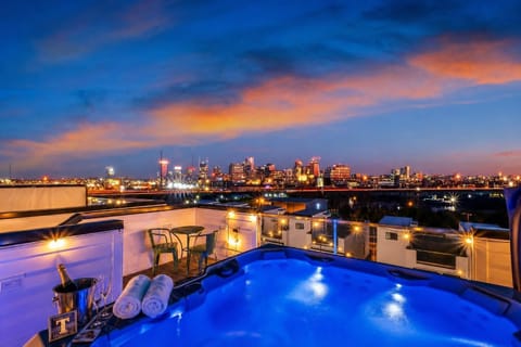 Champagne in hand, city lights below, string lights overhead: the rooftop hot tub at sunset is the image your group will text each other about for the next year