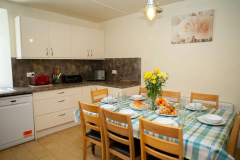 Fitted kitchen/dining area: dishwasher, microwave, toaster, dining table and eight chairs