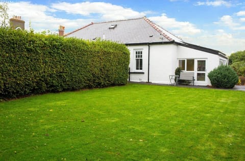 Large lawn area with matures hedges and bushes