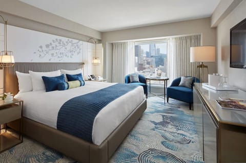 Unwind in a plush king bed with skyline views.