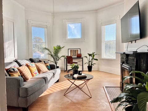 Living room with pullout sofa and workspace. 