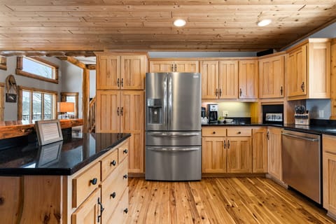 Your fully equipped kitchen awaits with stainless steel appliances, granite counters, and warm wood cabinetry for creating memorable meals together.