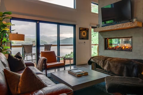 Main level living room with cozy seating, fireplace and smart TV.  Amazing lake and mountain skyline views.