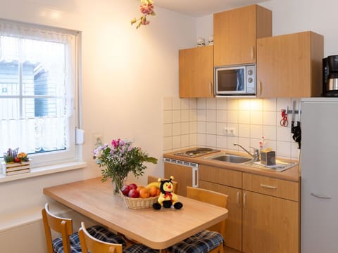 Cabinetry, Property, Furniture, Table, Countertop, Window, Flower, Interior Design, Wood, Sink