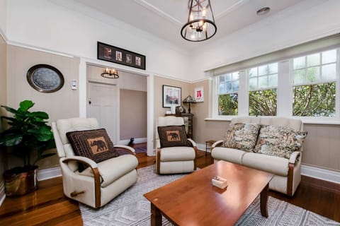 Lounge room with ample seating and TV.
