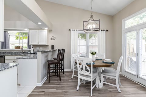 Dining room table seating four in addition to bar stool seating
